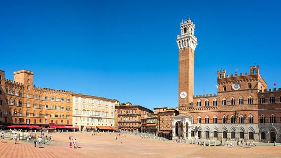 Panorama of Piazza del Campo (Campo square), Palazzo Publico and Torre del Mangia (Mangia tower) in Siena, Tuscany, Italy