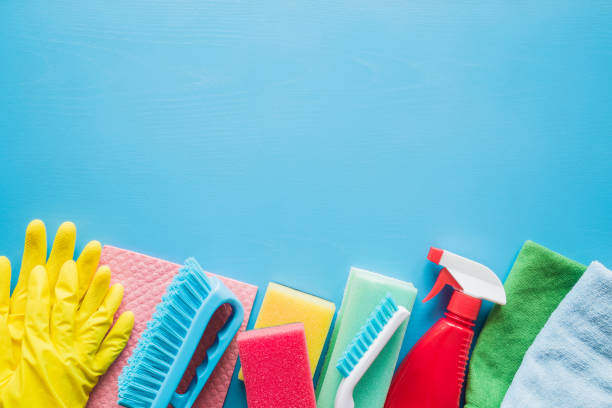 istock Colorful cleaning set for different surfaces in kitchen, bathroom and other rooms. Empty place for text or logo on blue background. Cleaning service concept. Early spring regular clean up. 918087468