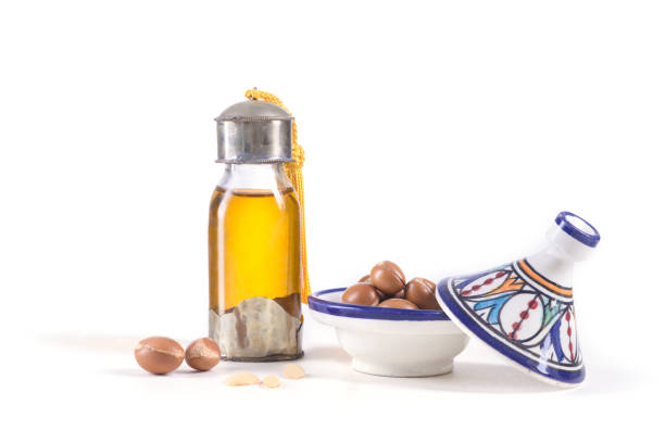 istock Argan oil and fruits on white 918087788