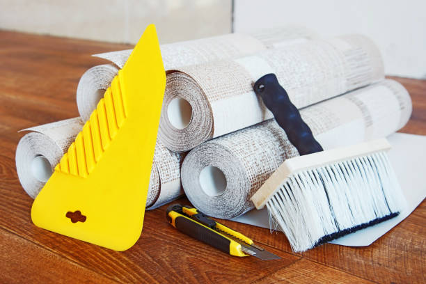 istock Composition with many rolls of wallpaper and tools for wallpapering 918087860