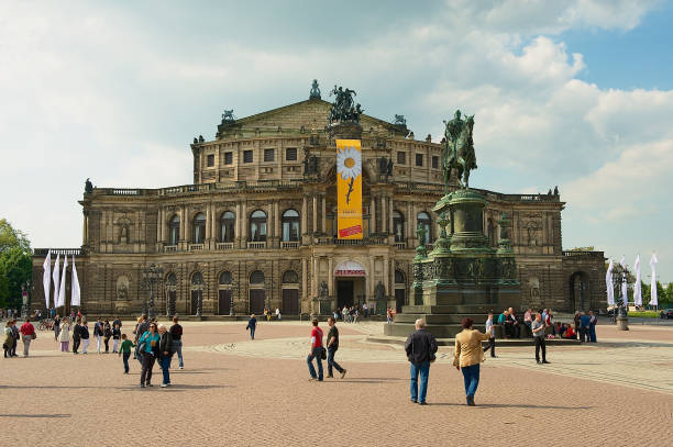 people walk by the theater square in front of the semper opera house, in dresden, germany. - opera house semper opera house statue theaterplatz imagens e fotografias de stock