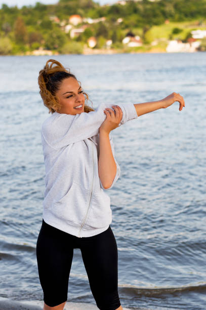 istock Sport woman making stretching before running 918091266