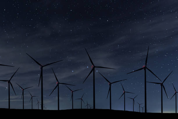 istock Night Sky Over Wind Farm. Energy and nature Night Sky. 918094458