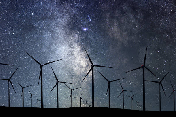 istock Night Sky Over Wind Farm. Energy and nature Night Sky. 918094816