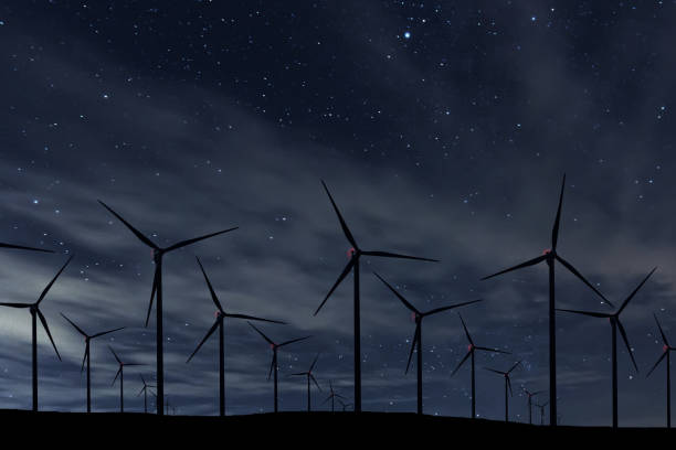 istock Night Sky Over Wind Farm. Energy and nature Night Sky. 918095012