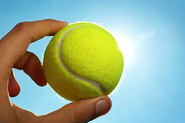 istock Hand holding tennis ball up to the sky 91809511