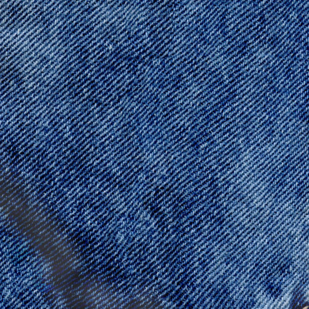 istock Closeup view blue clean denim texture. Blue torn jeans texture 918095218