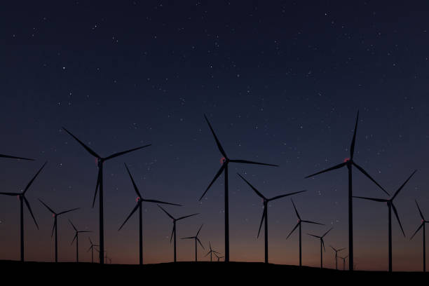 istock Night Sky Over Wind Farm. Energy and nature Night Sky. 918096052