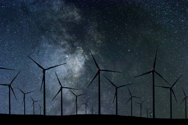 istock Night Sky Over Wind Farm. Energy and nature Night Sky. 918098644