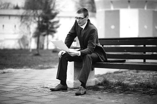 Businessman in a suit on the street black-and-white photo