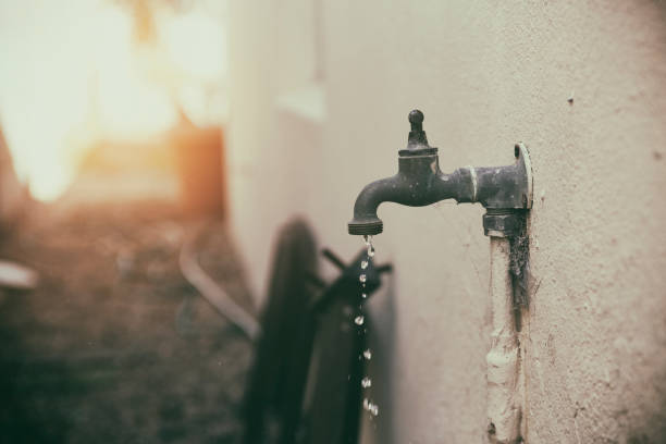 Water drips from water tap or faucet, wasting water