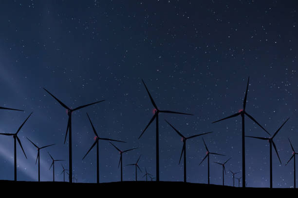 istock Night Sky Over Wind Farm. Energy and nature Night Sky. 918099400
