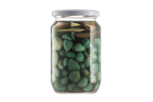 istock Garlic conserved in a glass jar on white background. 918102916