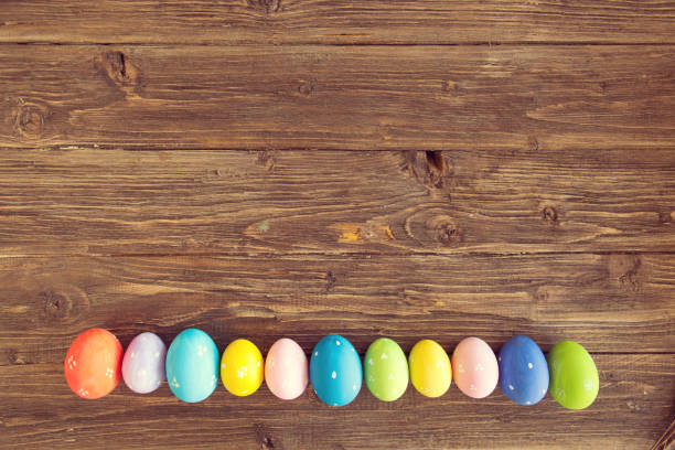 istock Line of easter eggs with on the wooden background 918103564