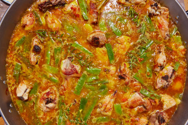 istock Paella from Spain recipe process boiling broth 918106006