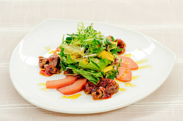 istock exquisite salad with mango and meat in a white plate background table setting, cozy restaurant serving close-up 918107276