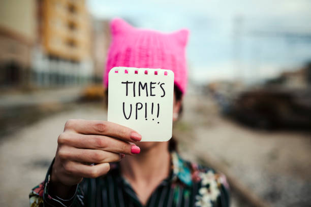 istock woman with a pink hat and the text time is up 918111138