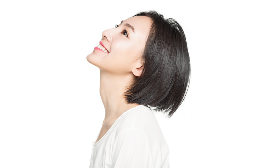 beautiful woman smiling over white background,China.