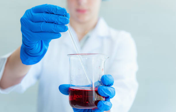 istock Research scientist stir and mixing liquid chemical in beaker 918114462