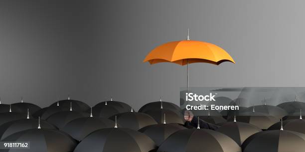 Orange Colored Umbrella Between The Black Umbrellas Stock Photo - Download Image Now