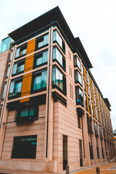 istock orange modern apartment building with square glass windows 918120342