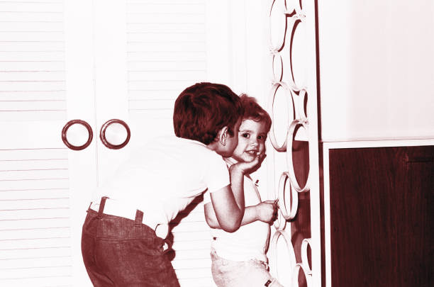 vintage image of a boy kissing his little sister - happy kid flash imagens e fotografias de stock