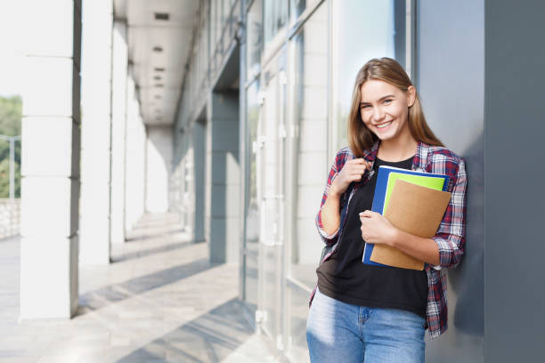 istock Student girl with books on university background 918121300