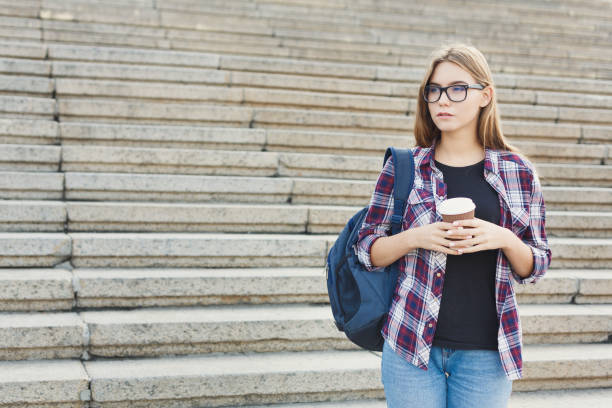 istock Student girl standing with coffee cup outdoors 918124078