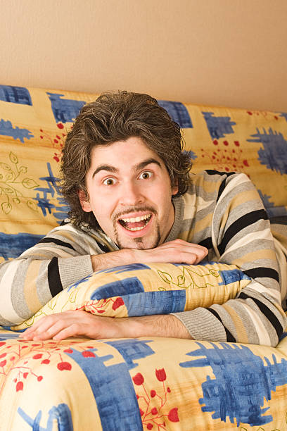 istock Young surprised handsome male on colourful sofa 91812678