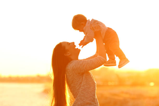 istock Mother raising her kid son at sunset 918128612