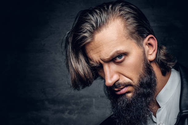 istock Bearded male with long hair on grey background. 918131250