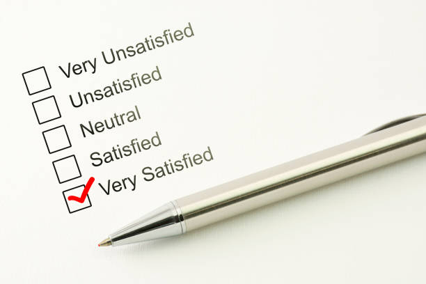 istock Satisfied customer service feed back. Consumer satisfaction concept. Marked checkbox with a pen on paper background 918132210
