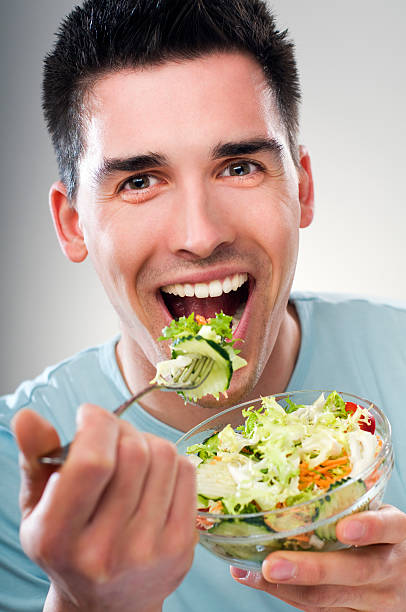 istock Young male enjoying a colorful salad 91813471