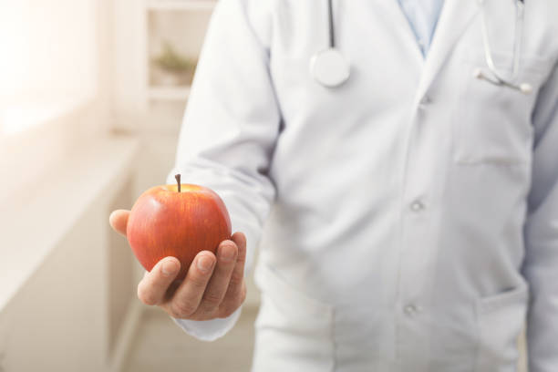 istock Apple in doctor's hand closeup 918139140