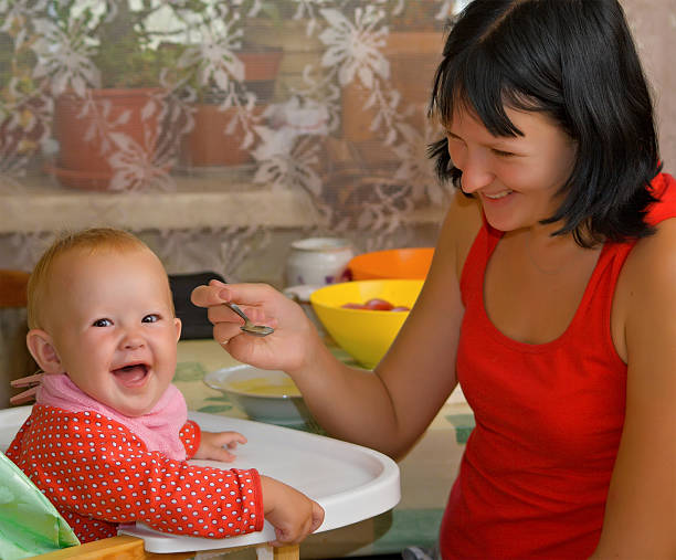istock mother feeds the little daughter 91814196