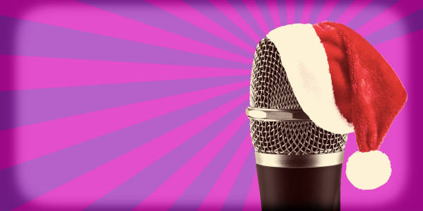 istock Santa Claus Hat on wireless microphone on purple stripes background 918142260