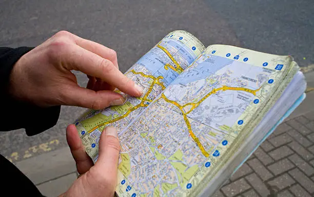 Photo of Tourist studying  map