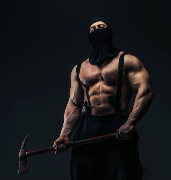 istock Muscular man in mask holding axe 918143590