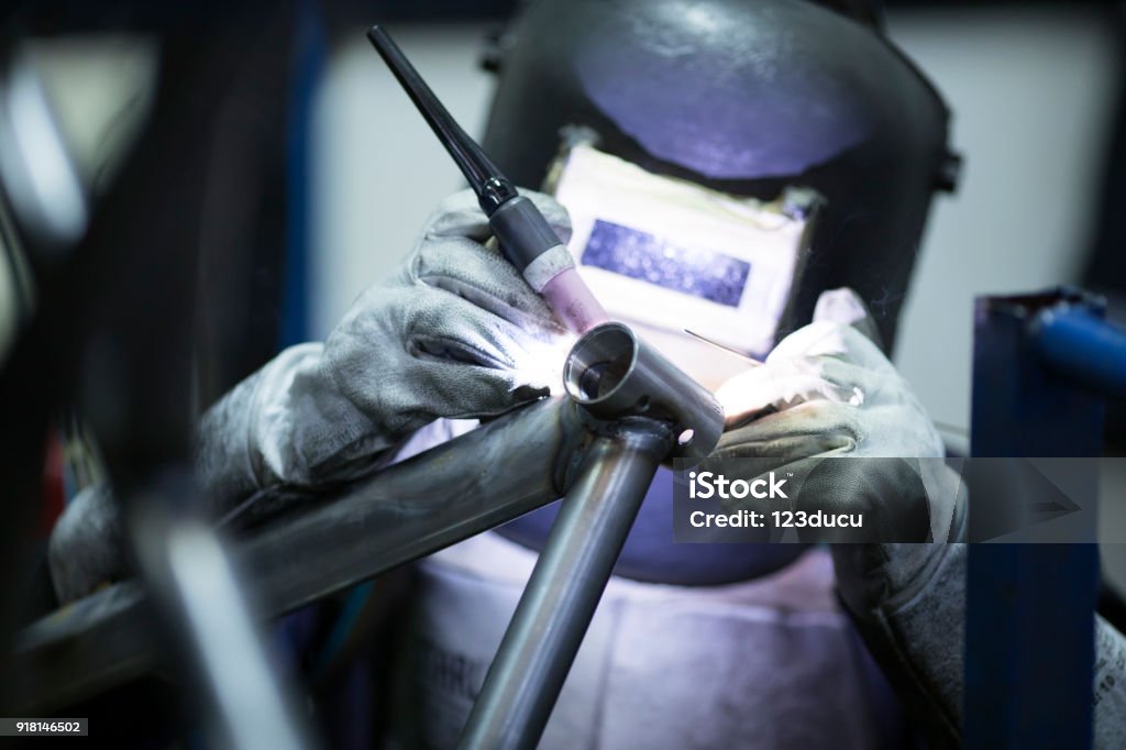 Welder Working Welder working at bicycle factory Bicycle Stock Photo