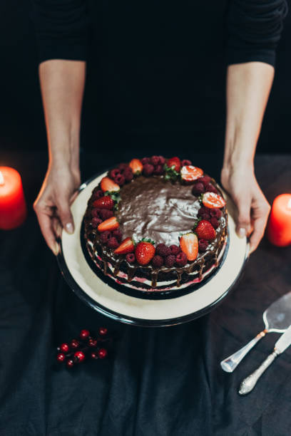 istock woman putting cake stand on table 918146760