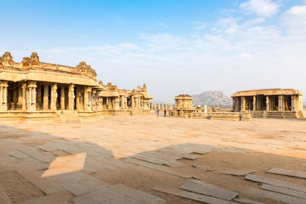 istock Garuda stone chariot and Vitthala temple gopuram, Hampi, Karnataka, India 918146880