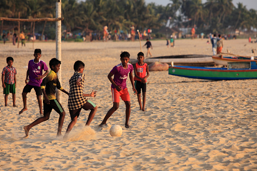 Kasargod, India -January 01,2018 : Unidentified children play football in the sandy beach of Bekal in Kasargod, Kerala, India