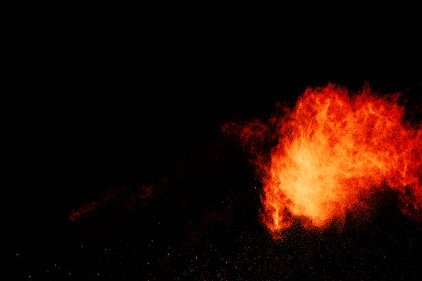 istock Red orange color powder explosion cloud isolated on black background. 918150054