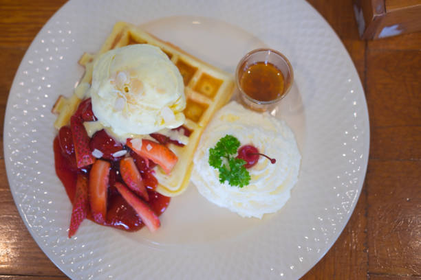 istock Belgium waffles with  strawberry and ice cream, top view 918150060