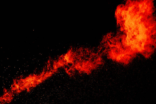 istock Red orange color powder explosion cloud isolated on black background. 918150136