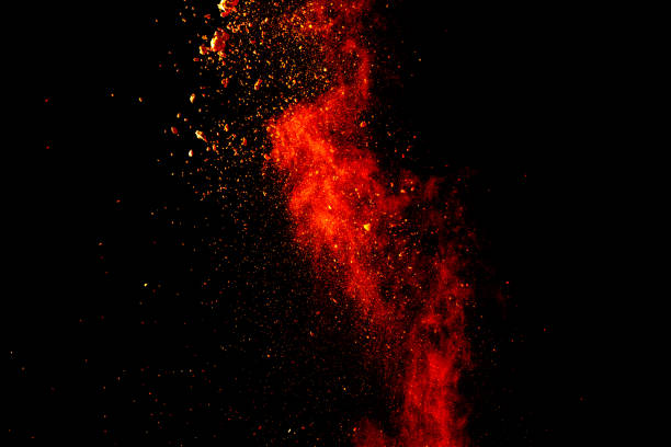 istock Red orange color powder explosion cloud isolated on black background. 918150148