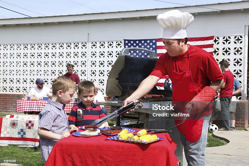 Man cooking at a 4th of July Barbecue  Barbecue Grill Stock Photo