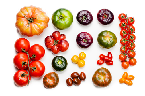 Collection of large variety of multi colored ripe tomatoes shot from above on white background. DSRL studio photo taken with Canon EOS 5D Mk II and Canon EF 100mm f/2.8L Macro IS USM