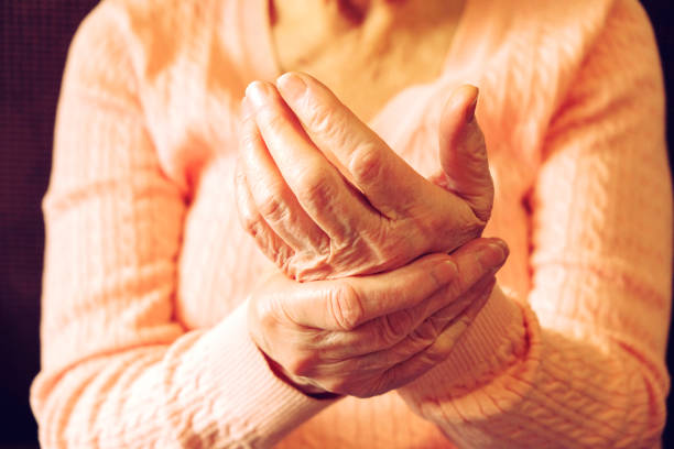 Close up of mature womans hands. Health care giving, nursing home. Parental love of grandmother. Old age related diseases. Elderly woman applying moisturizing lotion cream on hand palm, easing aches. Senior old lady experiencing severe arthritis rheumatics pains, massaging, warming up arm. Close up, copy space, background osteoarthritis photos stock pictures, royalty-free photos & images