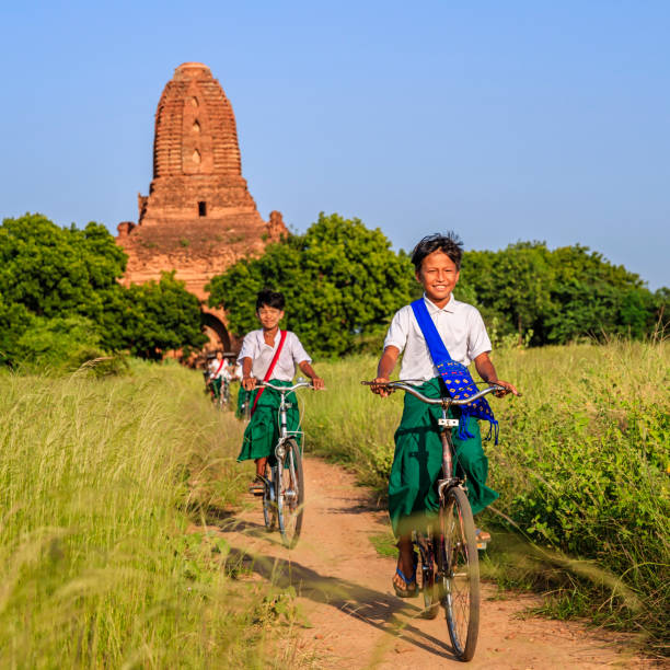 istock Burmese school children riding a bicycle in Bagan, Myanmar 918154178